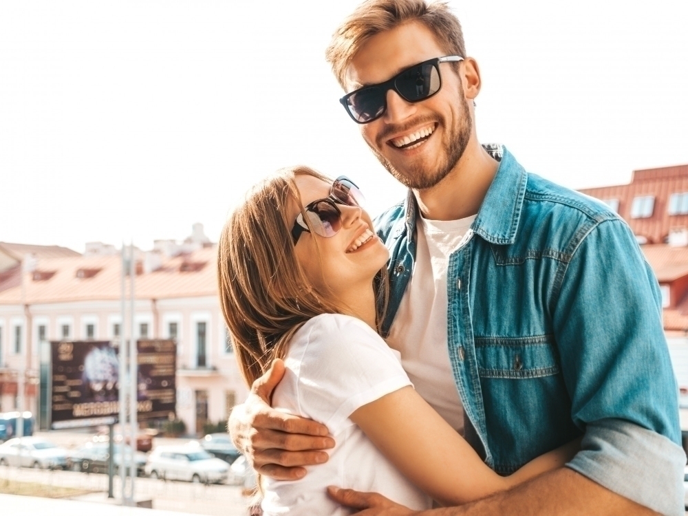 Portrait of smiling beautiful girl and her handsome boyfriend. Woman in casual summer jeans clothes.