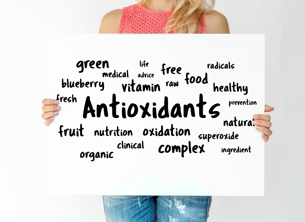 woman-holding-board-with-antioxidants-concept